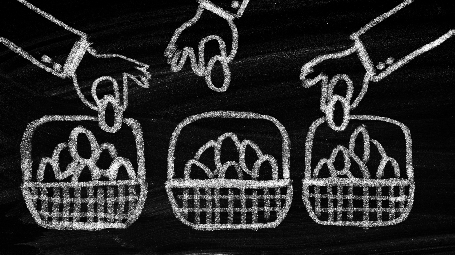 drawing of hands putting eggs in a basket on a chalkboard